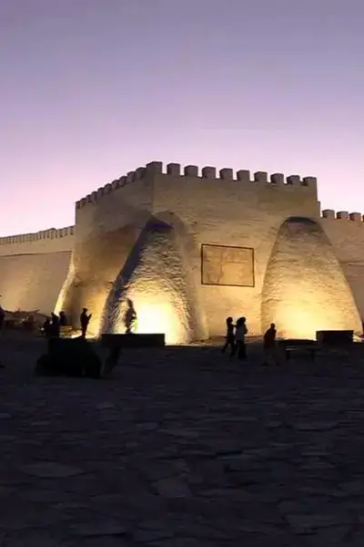 Anza fortress plaza at dusk with whitewashed walls and a lavender sky – agadir morocco surf